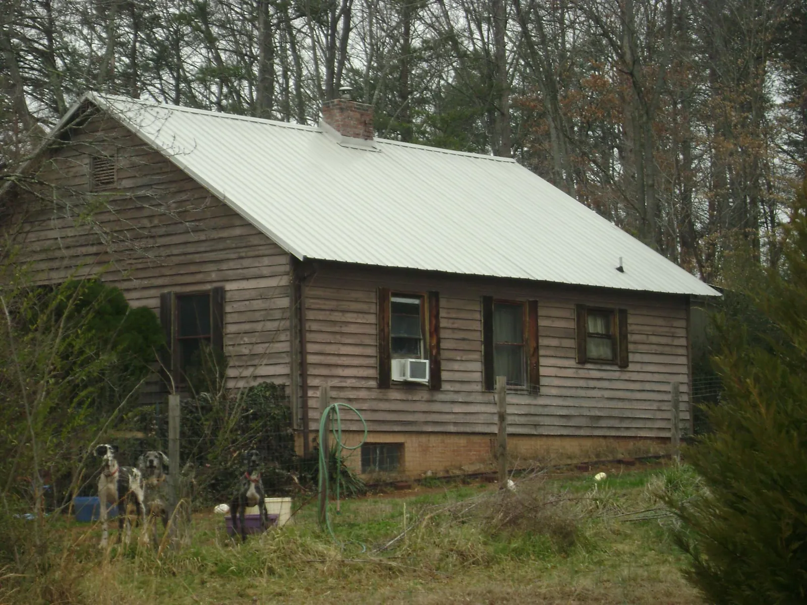 White metal roof on an old wood sided farmhouse, from a Metal Roof Installation job in Cottondale